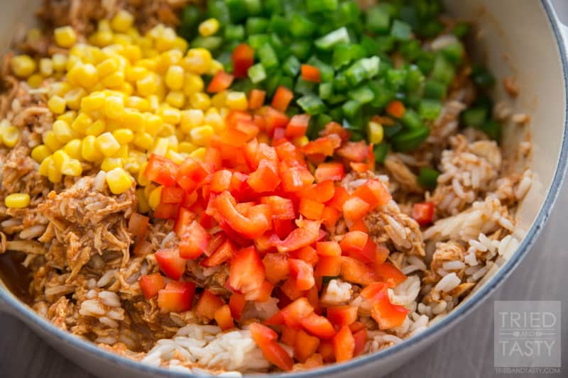Chicken Taco Rice Salad // Want an easy weeknight meal that the whole family will love? Try this super family friendly flavor packed chicken dish on your next menu! Serve it atop Fritos corn chips, sprinkled with fresh cheddar cheese and you've got an out of this world dinner! One to be made again and again! | Tried and Tasty