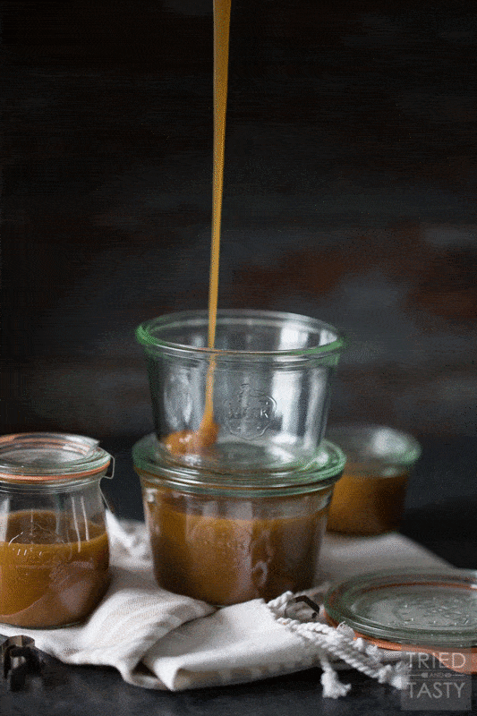 Glass jar being filled with homemade caramel