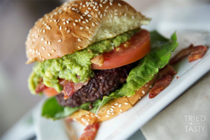 Guacamole Bacon Burger // If you love guacamole, you'll love this burger. It's got the wonderful flavors of guacamole paired with bacon on top of a well-seasoned grilled burger. You won't be disappointed! | Tried and Tasty