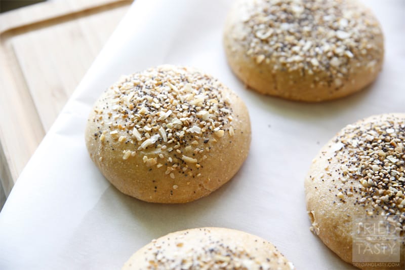 Homemade Whole Wheat Everything Hamburger Buns // If you are familiar with the 'everything' bagel and love it, you will love this hamburger bun. If you aren't familiar with it, you have GOT to give this a try. The smell alone of these baking in the oven is enough to make your senses run wild! | Tried and Tasty