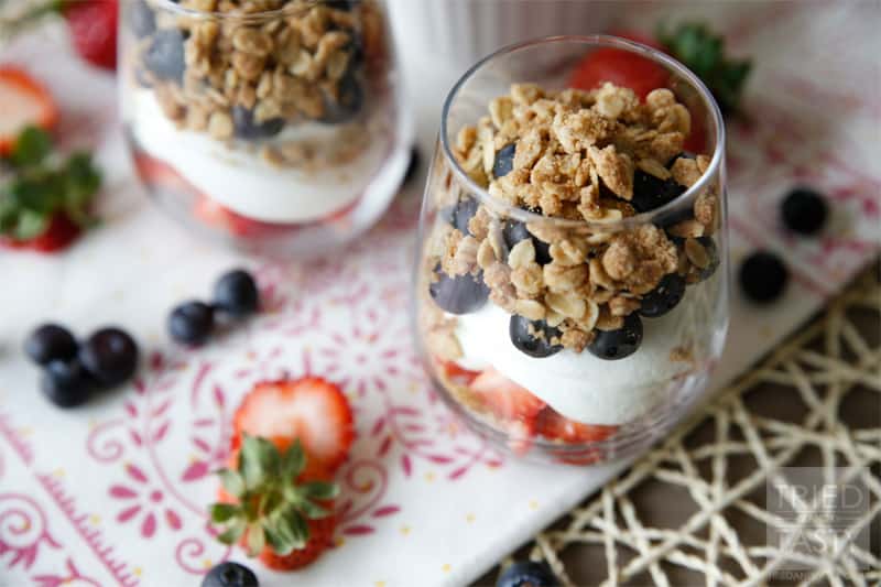 Red White & Blue Strawberry Blueberry Dessert Parfait // What better way to show your patriotism than with this beautiful dessert parfait. The lightly sweetened whipped cream with the fresh berries are wonderfully complimented by the crisp topping. | Tried and Tasty