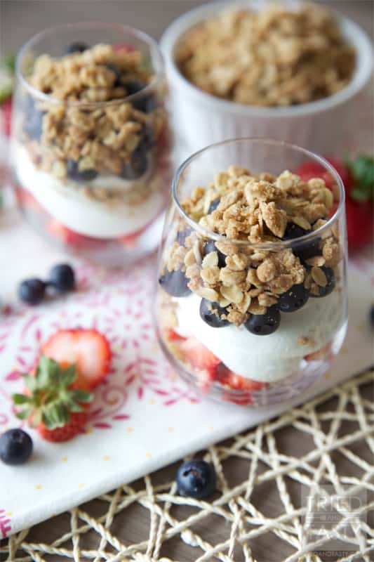 Red White & Blue Strawberry Blueberry Dessert Parfait // What better way to show your patriotism than with this beautiful dessert parfait. The lightly sweetened whipped cream with the fresh berries are wonderfully complimented by the crisp topping. | Tried and Tasty