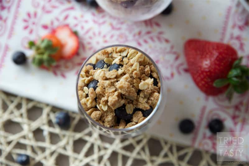 Red White & Blue Strawberry Blueberry Dessert Parfait // What better way to show your patriotism than with this beautiful dessert parfait. The lightly sweetened whipped cream with the fresh berries are wonderfully complimented by the crisp topping. | Tried and Tasty