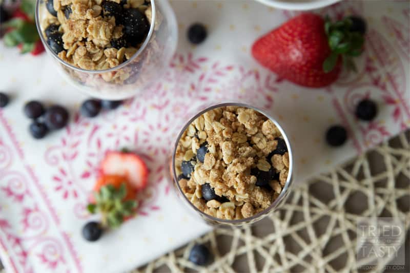 Red White & Blue Strawberry Blueberry Dessert Parfait // What better way to show your patriotism than with this beautiful dessert parfait. The lightly sweetened whipped cream with the fresh berries are wonderfully complimented by the crisp topping. | Tried and Tasty