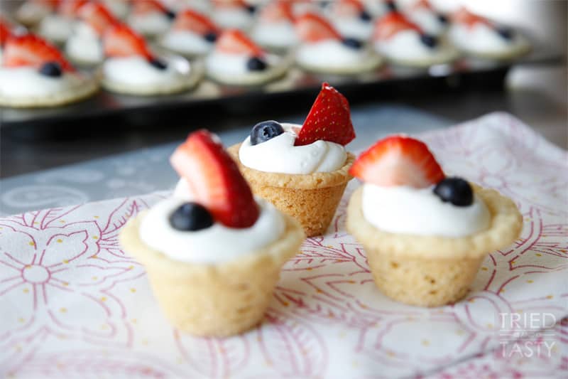 Red White & Blue Strawberry Blueberry Sugar Cookie Cups with Coconut Cream Cheese Filling // These scrumptious little treats are perfect party poppers! They are mini, fit right in the palm of your hand, and will be gobbled up in no time. With the tiniest hint of coconut, you'll be left wanting more! | Tried and Tasty