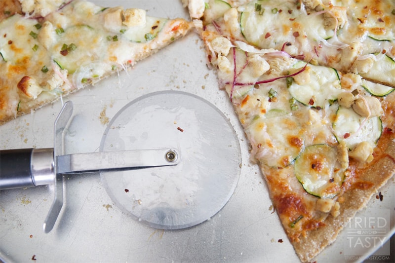 Thin Style Thai Chicken Pizza // Looking for a new way to experience pizza? This is a game changer! You've got to try the sweet sauce paired with garden fresh veggies, chicken, and of course cheese. Delightful! | Tried and Tasty