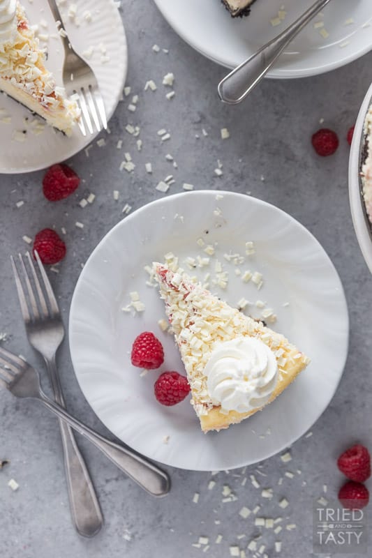 Slice of Cheesecake Factory White Chocolate Raspberry Truffle Cheesecake on a white plate