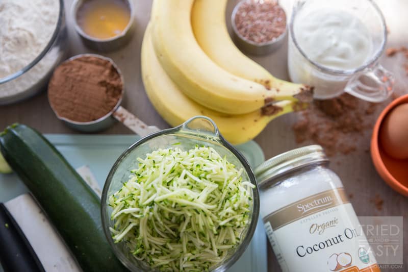 Bakery Style Healthy Chocolate Zucchini Muffins // Do you love bakery style muffins but don't love the long list of unrecognizable ingredients? These Healthy Chocolate Zucchini Muffins are perfect for you! Made without any refined flour or sugar, they are a guilt free breakfast option! | Tried and Tasty