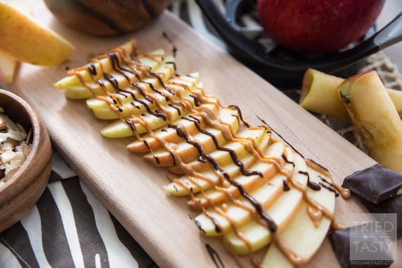 Chocolate Peanut Butter Apples with Coconut and Almonds // Want a sweet treat but not all the calories that typically come with them? These quick & easy apples are perfect! Just the right touch of sweetness to curb your sweet tooth while still being health conscious! | Tried and Tasty