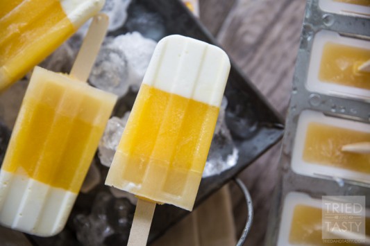 Tropical Candy Corn Popsicles // This 'candy corn' inspired treat is a healthy variation for all of your guilt-free treat needs! Perfectly tropcial with the flavors of coconut, pineapple and orange you're tastebuds will say THANK YOU! | Tried and Tasty