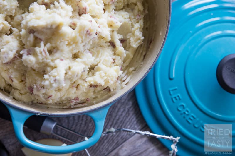 Dutch Oven Mashed Potatoes // Looking for a delicious but healthier mashed potato recipe? These out-of-this-world potatoes are made with only 4 ingredients and you won't believe the secret ingredient that makes them perfectly creamy! | Tried and Tasty
