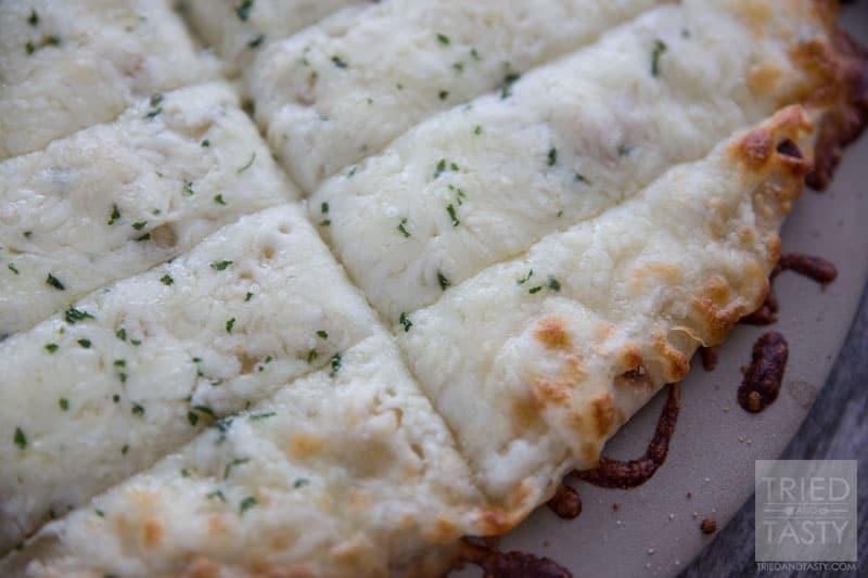 Copycat Pizza Hut Cheese Sticks // Why go out when you can have your restaurant favorites right at home? These Copycat Pizza Hut Cheese Sticks are perfectly cheesy and wonderfully delicious. On top of all of that, they are crazy simple and less than FIVE ingredients! | Tried and Tasty