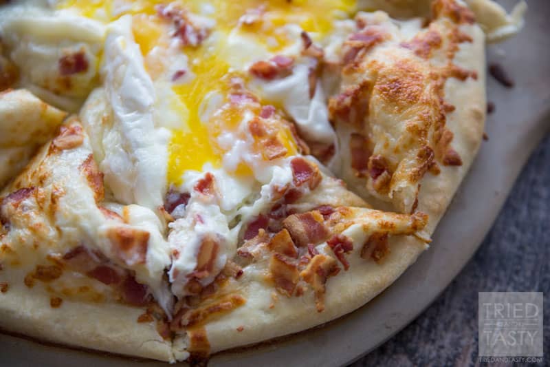 Breakfast Pizza // Make breakfast fun with this delicious pizza! Eggs, bacon and cheese + a crust is all you need. Great the morning of and also still tasty as leftovers! | Tried and Tasty