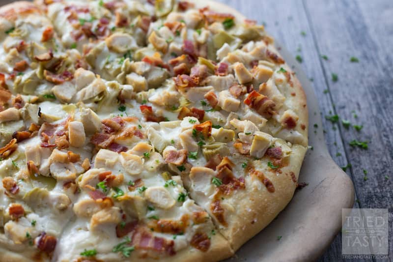Chicken Bacon Artichoke Alfredo Pizza // One of the best pizza combinations out there. Super simple to throw together, but packed with great flavor. Prepare a delicious crust and top with the best of the best. This pizza makes for a great lunch or dinner - and even delicious as leftovers! | Tried and Tasty