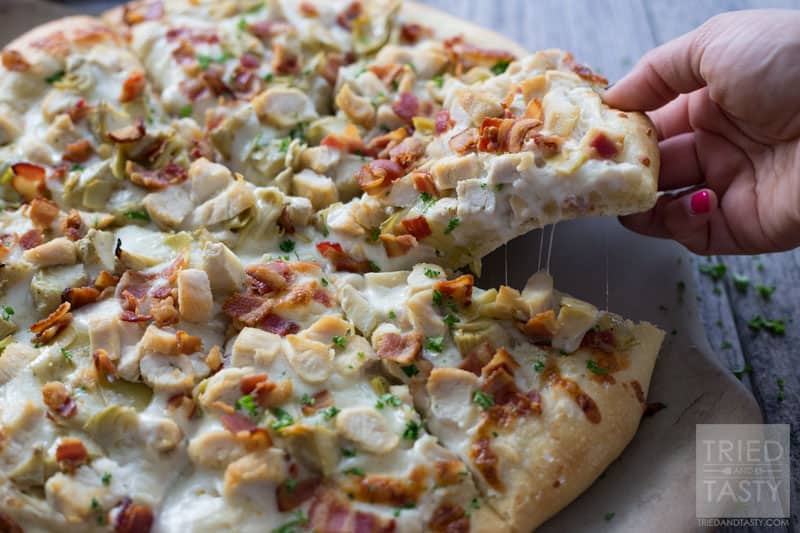 Chicken Bacon Artichoke Alfredo Pizza // One of the best pizza combinations out there. Super simple to throw together, but packed with great flavor. Prepare a delicious crust and top with the best of the best. This pizza makes for a great lunch or dinner - and even delicious as leftovers! | Tried and Tasty