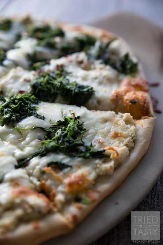 Roasted Garlic Pizza // You won't believe the flavor explosion that this pizza brings to the table. Made with three bulbs of freah roasted garlic, it's a flavor-packed cheesy delight you're sure to love! | Tried and Tasty