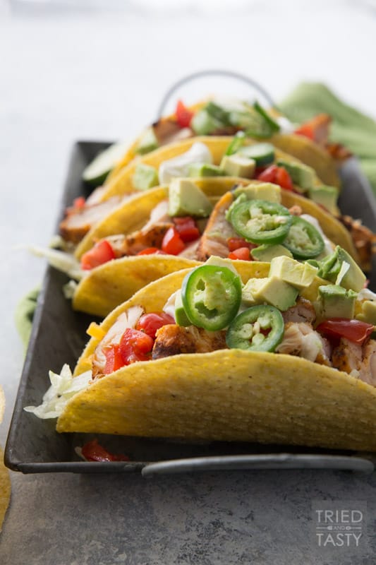Fire Grilled Chicken Tacos // You haven't had chicken tacos until you've had THESE chicken tacos! This quick and easy weeknight meal will solve your problem to get a meal on the table for those busy nights! You won't believe how tender and flavorful the chicken is! | Tried and Tasty
