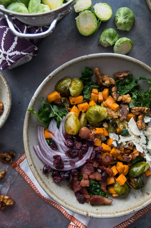 Sweet Potato, Kale and Brussels Sprouts Winter Bowl // This winter bowl is the perfect cure to the seasonal blues. Packed with delicious veggies and ever so slightly sweetened with maple candied walnuts and cranberries! | Tried and Tasty