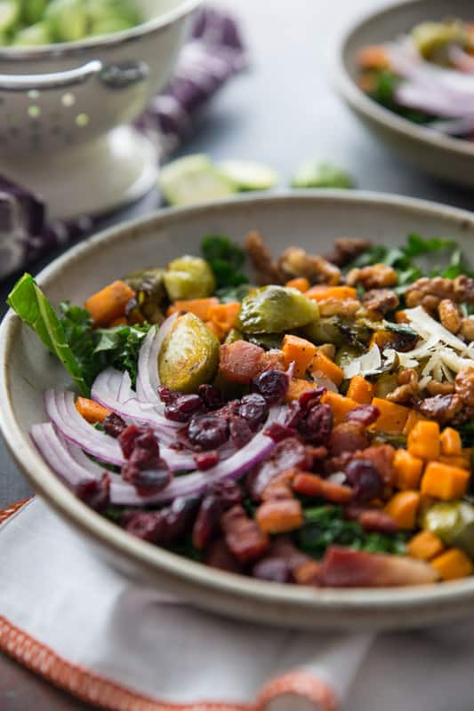 Sweet Potato, Kale and Brussels Sprouts Winter Bowl // This winter bowl is the perfect cure to the seasonal blues. Packed with delicious veggies and ever so slightly sweetened with maple candied walnuts and cranberries! | Tried and Tasty