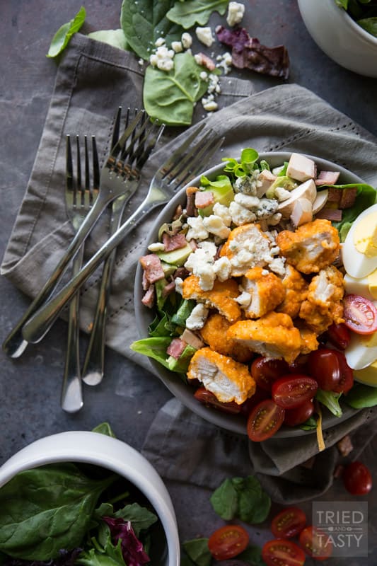 Buffalo Chicken Cobb Salad // Eating 'lighter fare' doesn't have to be tasteless and boring - I'm proving that to you with this delicious flavor packed salad! Comes together super easily and will keep you full through lunchtime and beyond. Take your Cobb salad to the next level, I promise you won't be sorry! | Tried and Tasty