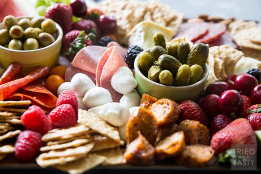 Fruit Lovers Summer Charcuterie // This taste of summer will wow your palate with all your favorite berries, cheeses, meats, and crackers. This is the perfect recipe for entertaining guests this summer! | Tried and Tasty.