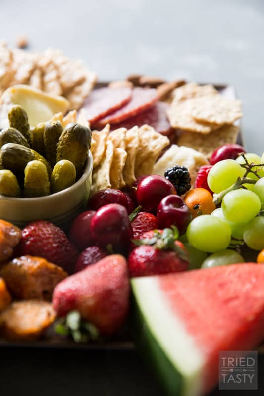 Fruit Lovers Summer Charcuterie // This taste of summer will wow your palate with all your favorite berries, cheeses, meats, and crackers. This is the perfect recipe for entertaining guests this summer! | Tried and Tasty.
