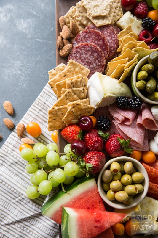 Fruit Lovers Summer Charcuterie // This taste of summer will wow your palate with all your favorite berries, cheeses, meats, and crackers. This is the perfect recipe for entertaining guests this summer! | Tried and Tasty.