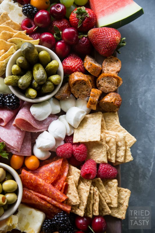 Fruit Lovers Summer Charcuterie // This taste of summer will wow your palate with all your favorite berries, cheeses, meats, and crackers. This is the perfect recipe for entertaining guests this summer! | Tried and Tasty.