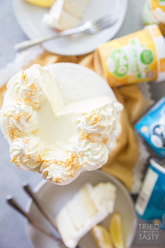 Lemon Lovers Ice Cream Cake // Calling all lemon lovers, this ice cream cake screams summer with the most delicious lemon cake sandwiched between a layer of lemon ice cream and a layer of vanilla bean ice cream covered in light and fluffy lemon whipped cream frosting! | Tried and Tasty