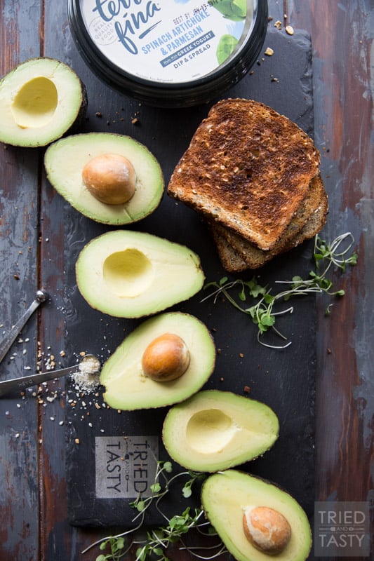 Savory Avocado Toast // This quick and easy snack that could double as breakfast or triple as lunch is simple to make & packed with nutrients! The twist? A smattering of spinach & artichoke dip underneath! | Tried and Tasty