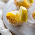Salted Lemon Tartlets // If you want a sweet ending to a delicious meal without going overboard these bite-sized lemony treats are just what you've been looking for! Super simple to make, the perfect amount of zing & a secret twist of perfect saltiness! | Tried and Tasty